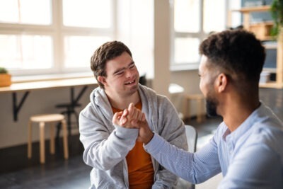 Special educator supporting a student with a disability through encouragement and connection
